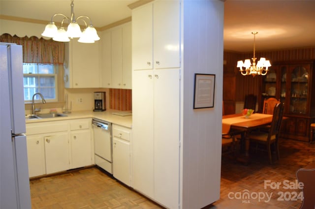 kitchen featuring white cabinetry, an inviting chandelier, sink, light parquet flooring, and white appliances