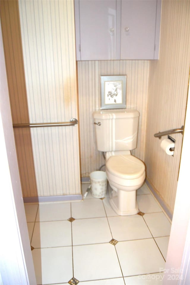 bathroom with toilet and tile patterned floors