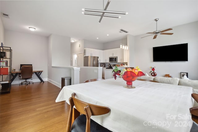 dining area with ceiling fan and light wood-type flooring