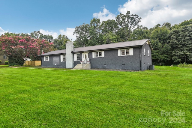 view of front of house featuring a front lawn and central AC unit