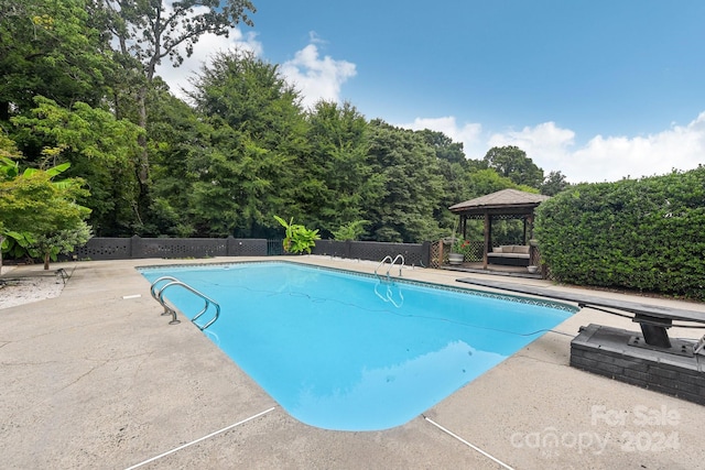 view of swimming pool featuring a gazebo and a patio area