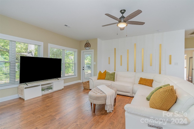 living room with ceiling fan and hardwood / wood-style flooring