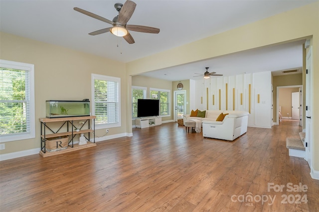 living room with hardwood / wood-style floors and ceiling fan