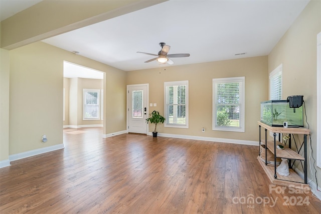 living room featuring ceiling fan and light hardwood / wood-style floors