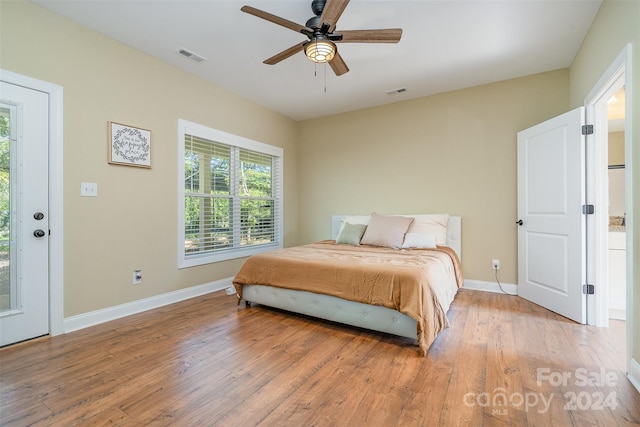 bedroom featuring ceiling fan, light hardwood / wood-style floors, and access to outside