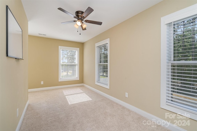 empty room featuring light carpet and ceiling fan