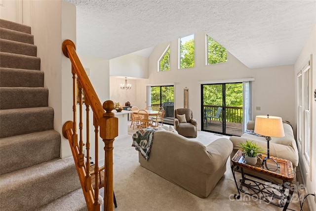 living room featuring a notable chandelier, a textured ceiling, high vaulted ceiling, and carpet flooring