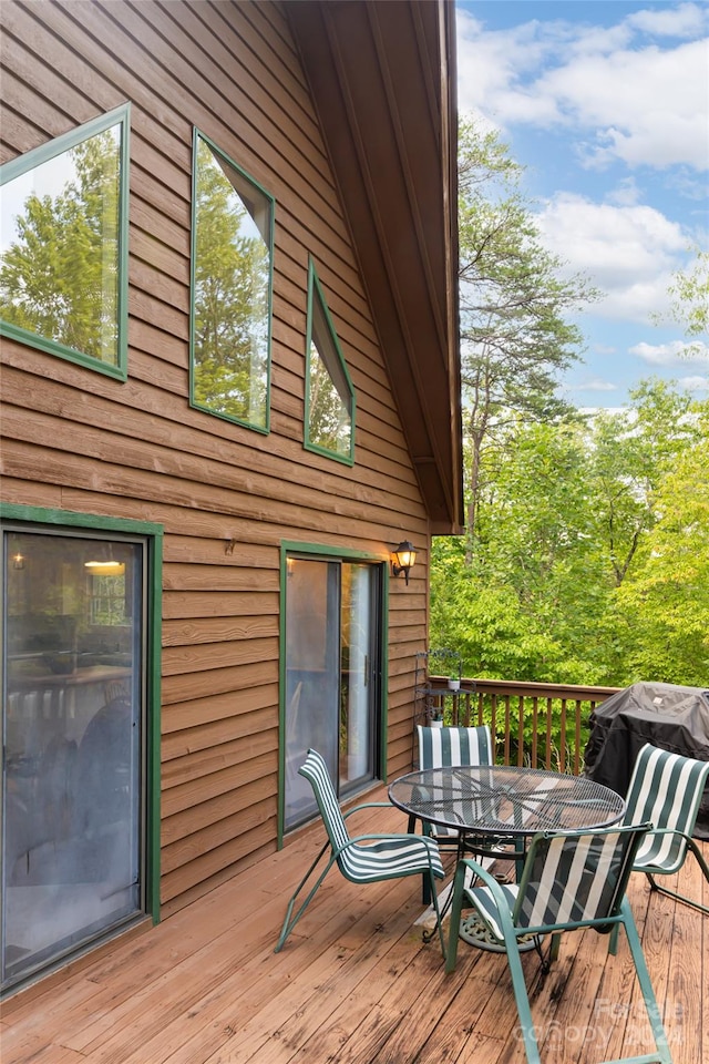 wooden deck with a grill