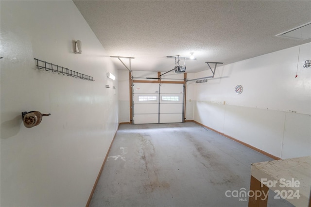 garage featuring a garage door opener and baseboards