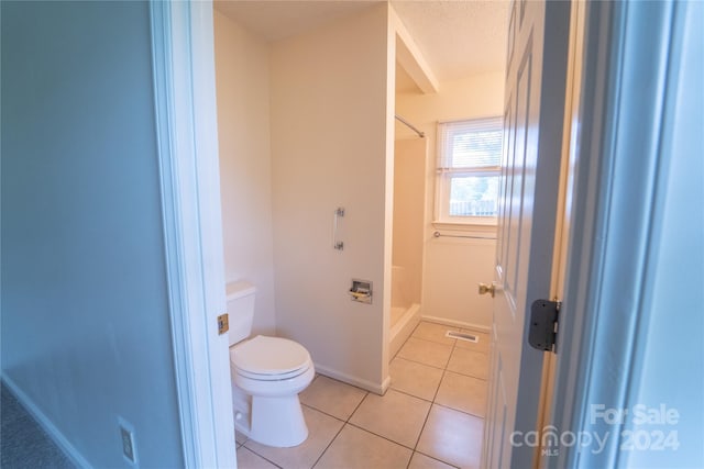 bathroom with visible vents, baseboards, toilet, tile patterned flooring, and a shower stall