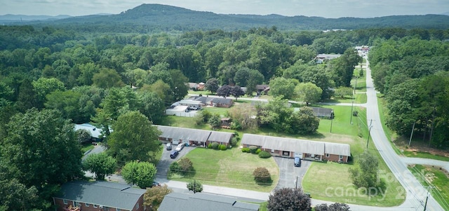 bird's eye view featuring a forest view and a mountain view