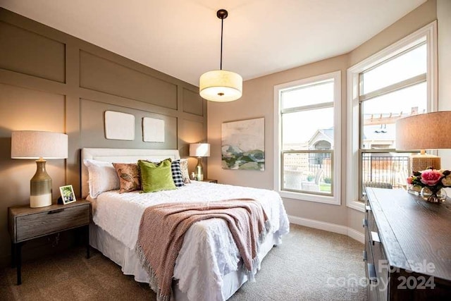 bedroom with carpet flooring and multiple windows