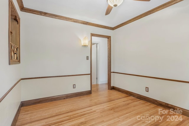 unfurnished room with crown molding, ceiling fan, baseboards, and light wood-style floors