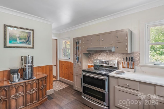 kitchen featuring gray cabinetry, ornamental molding, wainscoting, double oven range, and under cabinet range hood