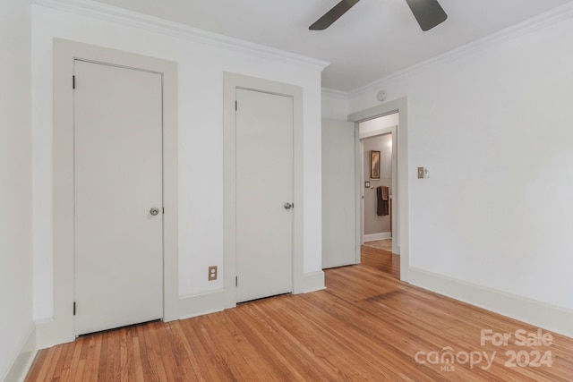 unfurnished bedroom featuring crown molding, baseboards, ceiling fan, and wood finished floors