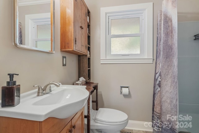 bathroom with toilet, baseboards, a shower with shower curtain, and vanity