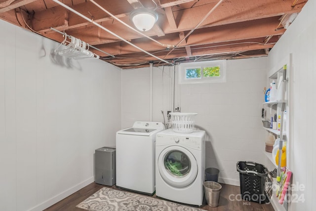 laundry area featuring laundry area, washer and dryer, and wood finished floors