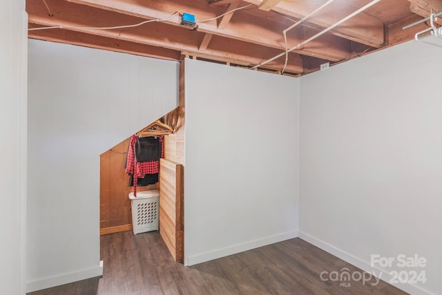 finished basement featuring baseboards and wood finished floors