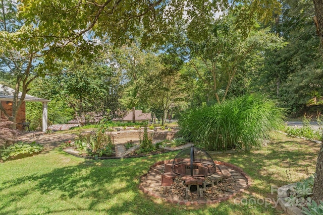 view of yard with a fire pit