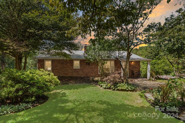 ranch-style house featuring a front yard and brick siding