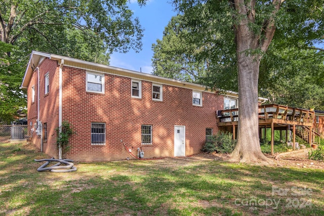 1573 Timberlake Dr, Shelby, NC 28150 - back of house featuring a yard, fence, brick siding, and a wooden deck
