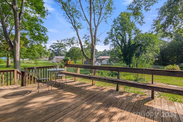 wooden terrace with a yard