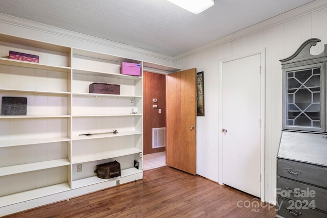 1573 Timberlake Dr, Shelby, NC 28150 - unfurnished bedroom featuring visible vents, a textured ceiling, wood finished floors, and crown molding