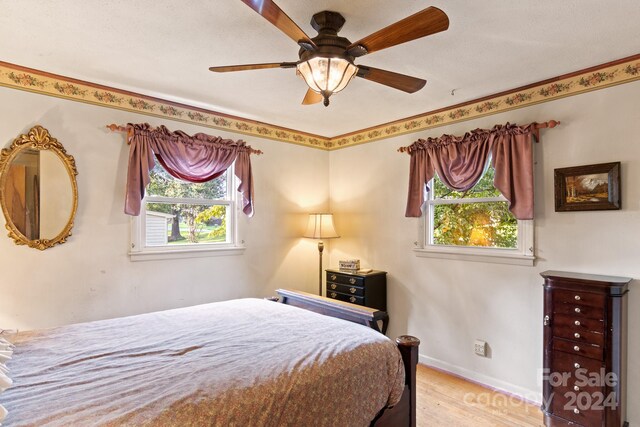 bedroom featuring light hardwood / wood-style flooring and ceiling fan