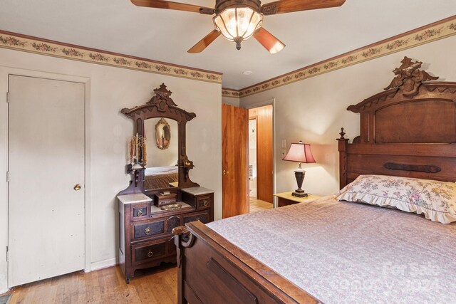 bedroom with light hardwood / wood-style flooring and ceiling fan