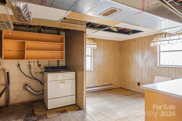 1573 Timberlake Dr, Shelby, NC 28150 - below grade area with visible vents, wood walls, washer / dryer, concrete block wall, and a baseboard radiator