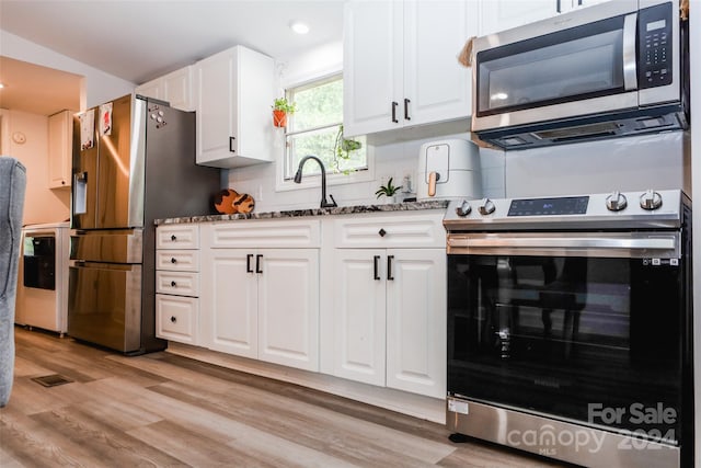 kitchen featuring decorative backsplash, dark stone countertops, light hardwood / wood-style floors, and stainless steel appliances