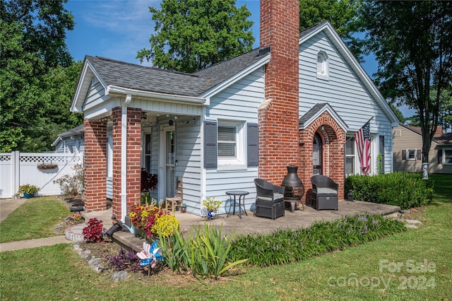 view of front facade with a front lawn and a patio area