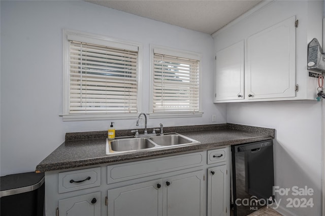 kitchen with black dishwasher, white cabinets, and sink