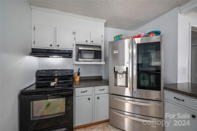 kitchen with dark stone counters, a textured ceiling, white cabinetry, and stainless steel appliances