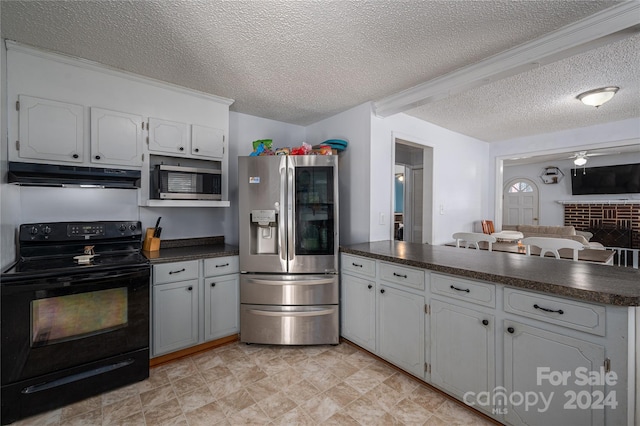 kitchen featuring a textured ceiling, white cabinetry, light tile patterned flooring, and stainless steel appliances