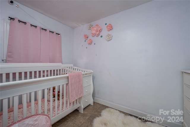 tiled bedroom with a crib