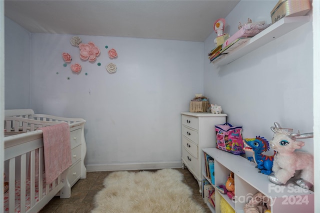 tiled bedroom featuring a nursery area