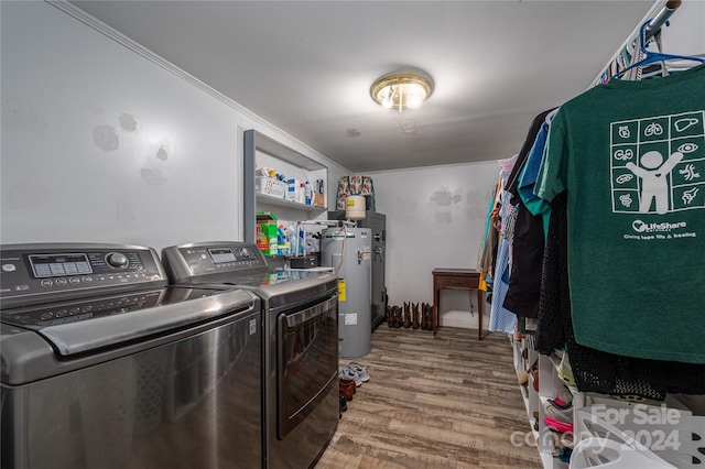 laundry area featuring gas water heater, hardwood / wood-style floors, crown molding, and washer and clothes dryer