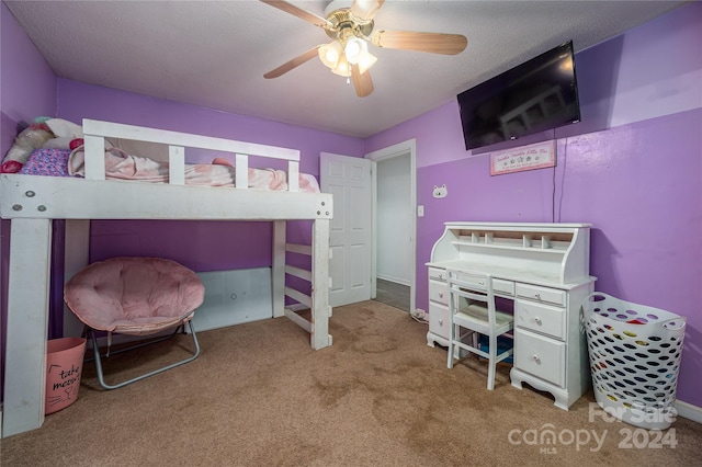 bedroom with ceiling fan, a textured ceiling, and carpet floors