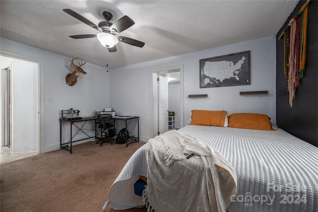 bedroom featuring a textured ceiling, ceiling fan, and carpet