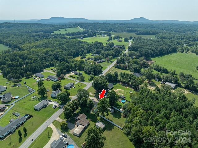 drone / aerial view with a mountain view and a wooded view