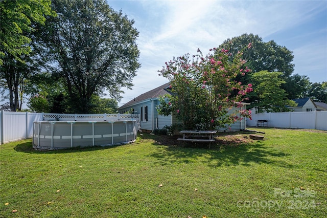 view of yard with a fenced in pool