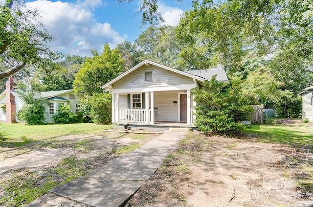 bungalow-style home featuring a porch and a front yard