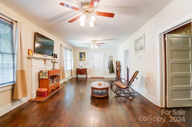 sitting room featuring dark hardwood / wood-style flooring and ceiling fan