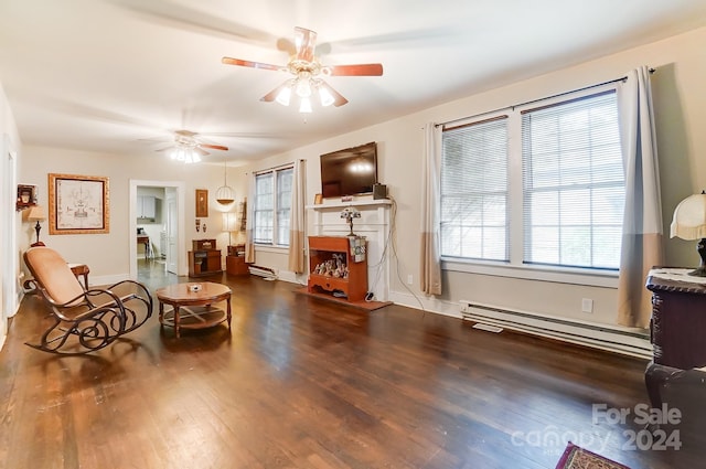 living area with ceiling fan, a baseboard heating unit, and wood-type flooring