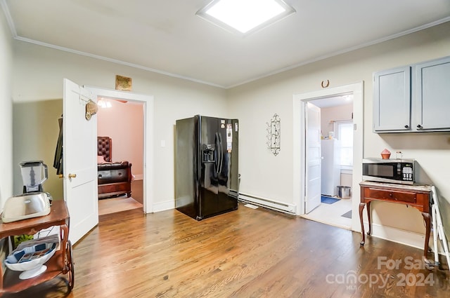 interior space with black refrigerator with ice dispenser, a baseboard radiator, crown molding, and light wood-type flooring