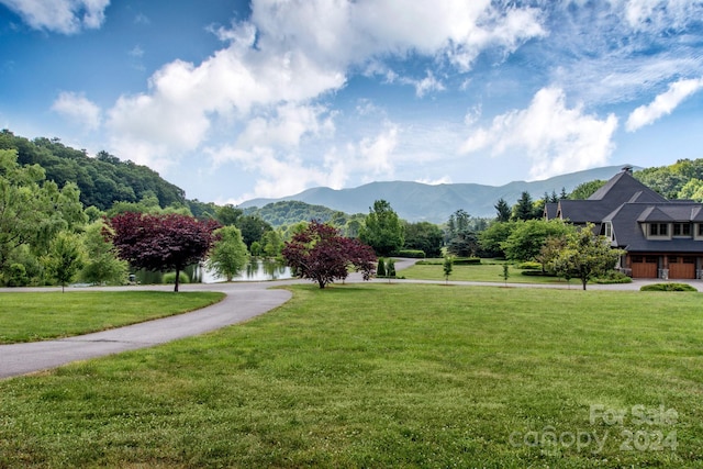 view of community featuring a mountain view and a yard