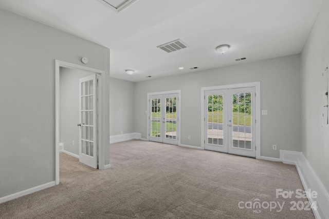 carpeted empty room with french doors