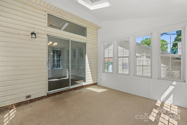 unfurnished sunroom featuring vaulted ceiling