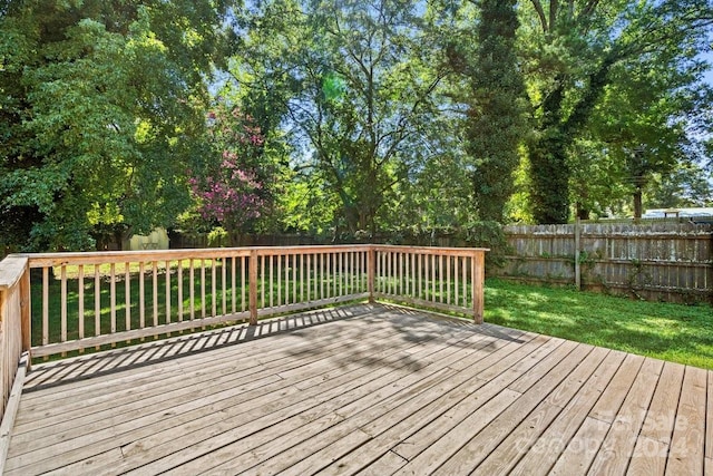 wooden deck featuring a yard